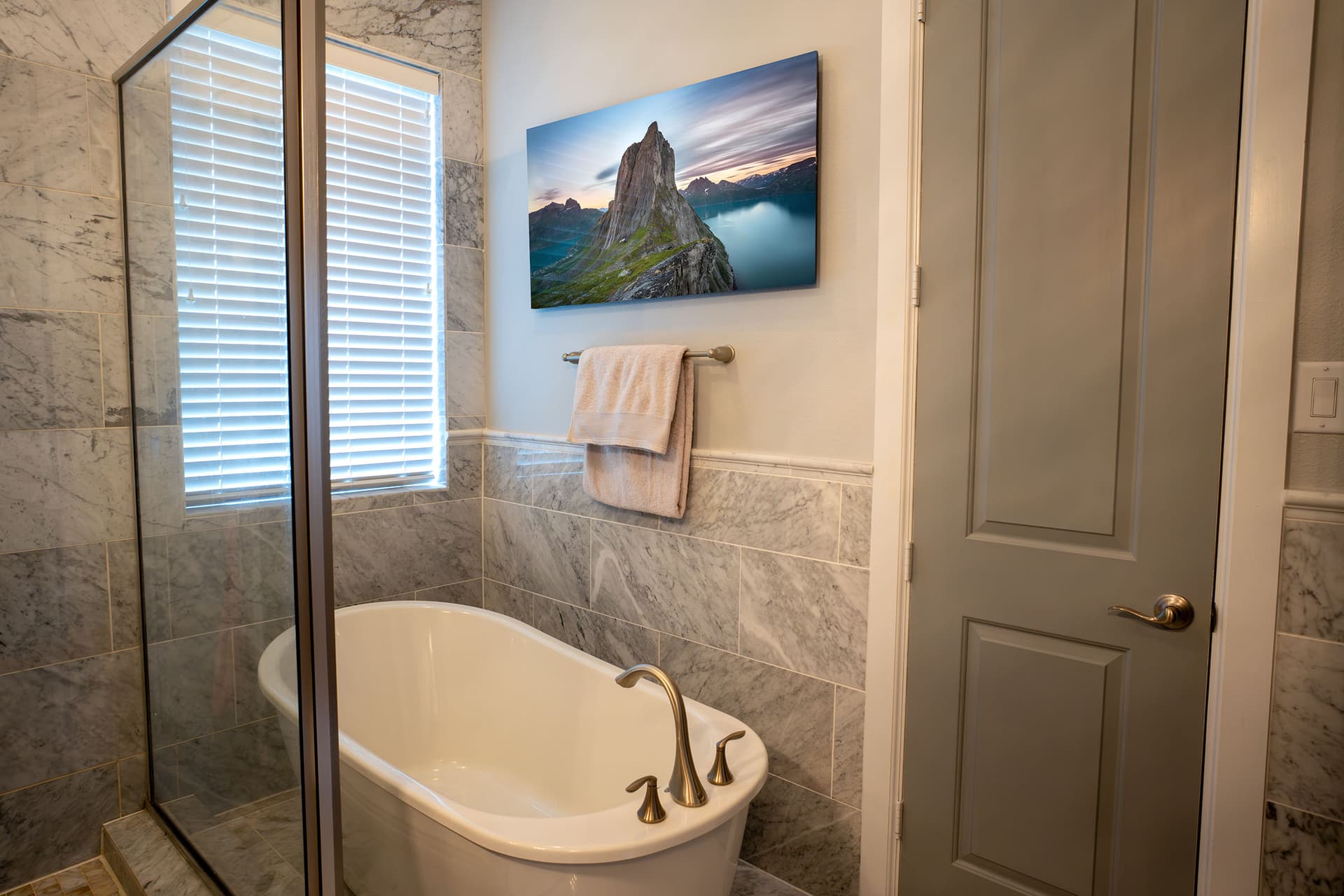 Escalate, Segla Mountain print hanging above a bathtub