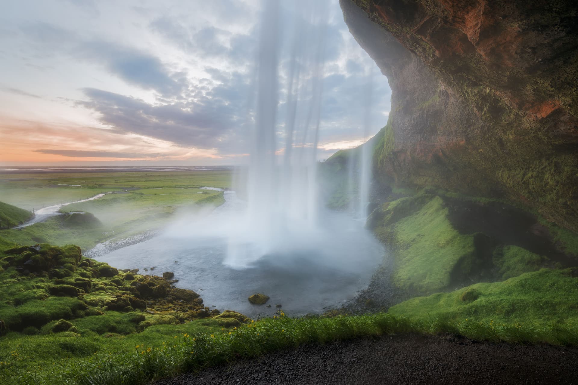 View From Behind Seljalandsfoss Waterfall Iceland Background