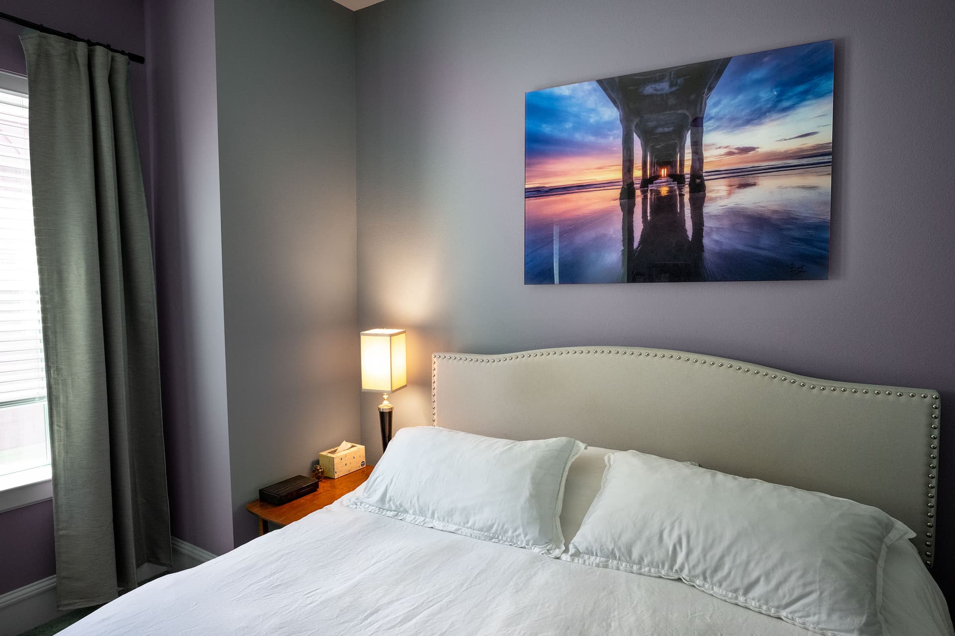 Under, Manhattan Beach Pier print hanging above a bed