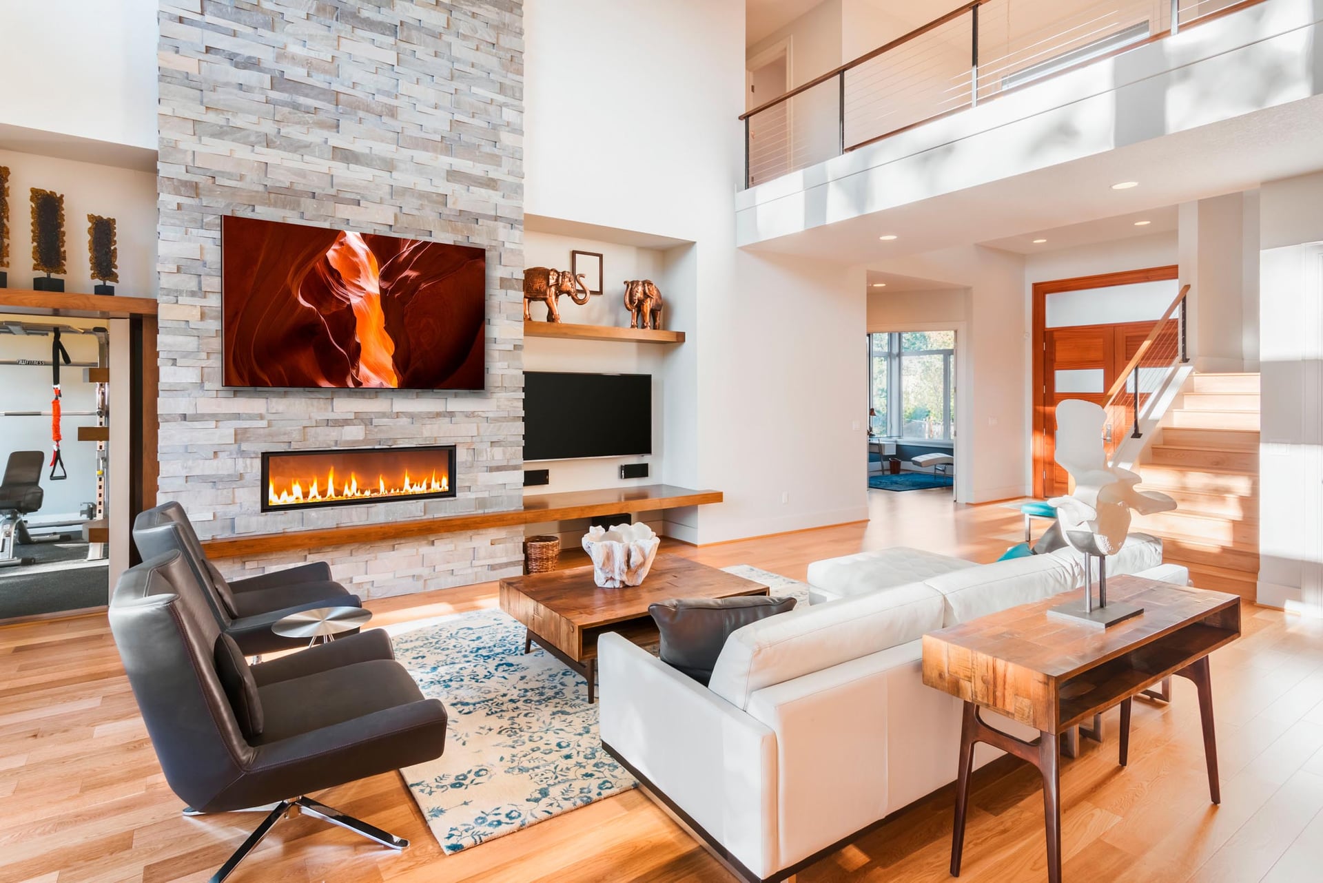 A warm toned Antelope Canyon print mounted on a stone fireplace wall in an open plan great room